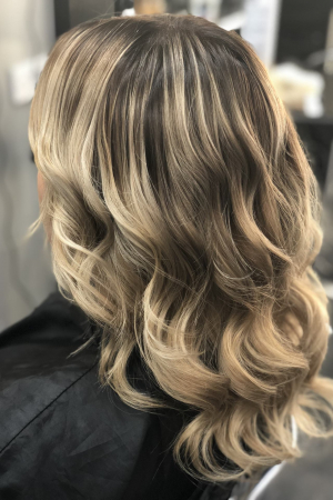 A gorgeous Balayage result on a client That had old highlights. A root stretching technique was used to create this final look